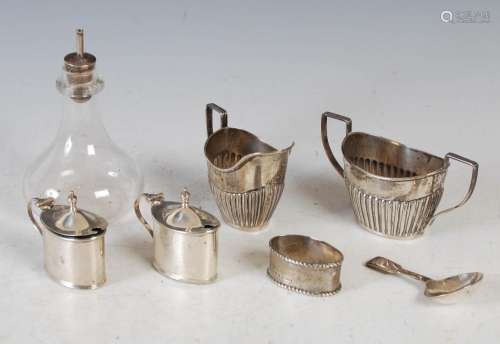 A group of silver, to include an Edwardian oval shaped sugar...