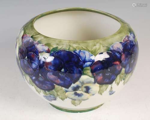 A Moorcroft pottery jardiniere, decorated with pansies on a ...