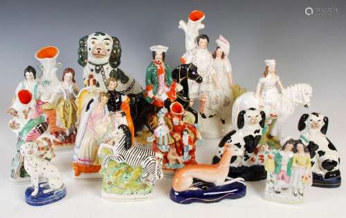 A collection of fourteen assorted Staffordshire figures, to ...