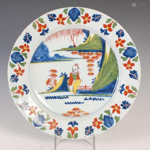 An 18th century Delft charger, decorated in the Fazackerley ...