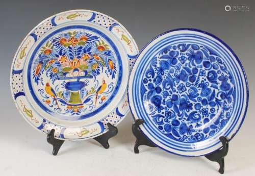 Two Continental Delft pottery chargers, one decorated with a...