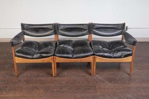 A Modus rosewood and black leather three seat sofa