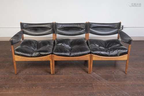 A Modus rosewood and black leather three seat sofa