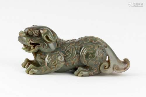 A Chinese jadeite figure of a recumbent lion dog, 9 3/4 in. ...