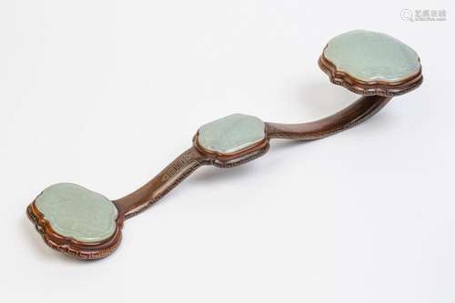 A Chinese Qing dynasty hardwood and celadon white jade ruyi ...