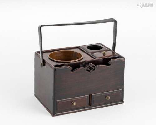 A Japanese hardwood ceremonial tea box with a handle