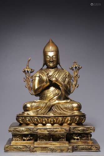In the Qing Dynasty, a sitting bronze gilt statue of Master ...