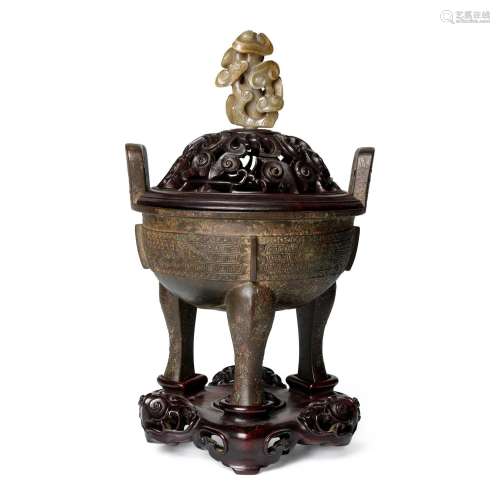 AN ARCHAISTIC BRONZE TRIPOD CENSER, DING, WITH AN ATTRACTIVE...