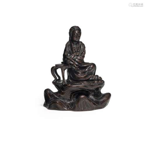 A FINE DARK-PATINATED BRONZE FIGURE OF GUANYIN 17th or possi...