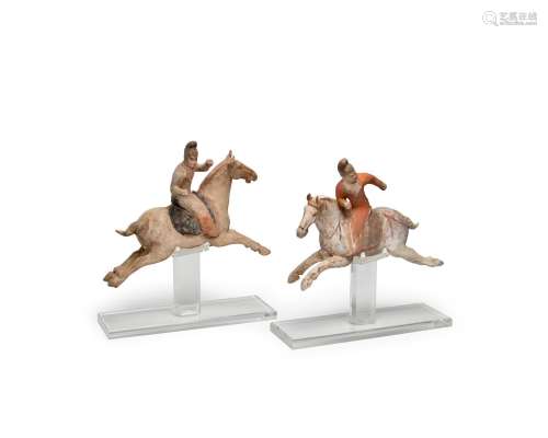 A PAIR OF PAINTED POTTERY FIGURES OF POLO PLAYERS Tang dynas...