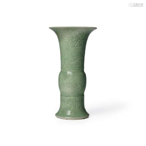 AN UNUSUAL CARVED AND CELADON-GLAZED GU-SHAPED BEAKER VASE K...