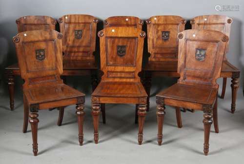 A set of eight George IV mahogany hall chairs