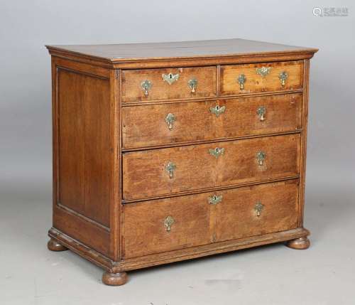 A George I provincial oak chest of drawers with fruitwood cr...