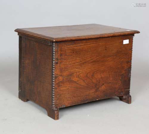 An 18th century oak and elm six-plank coffer of small propor...