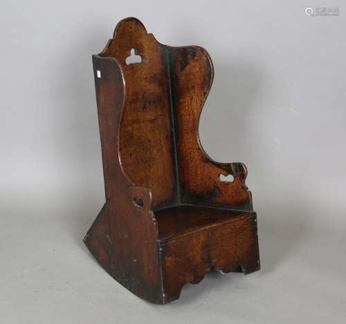 An early 19th century Welsh oak child's rocking armchair wit...