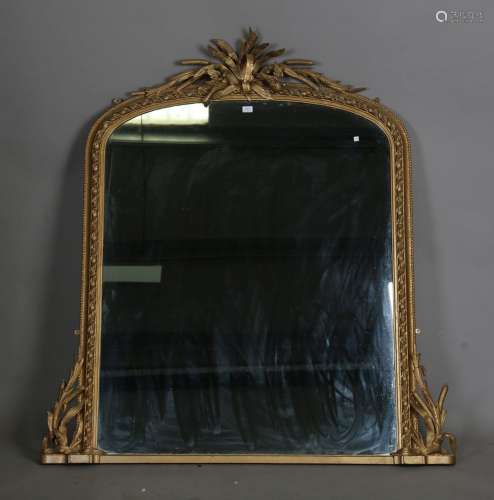 A late Victorian gilt composition arched overmantel mirror