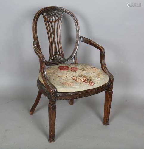 A late George III Neoclassical walnut framed elbow chair wit...