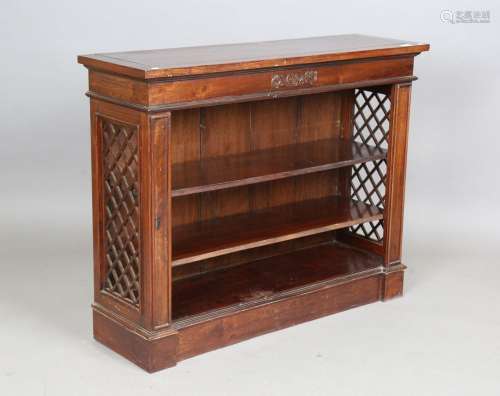 A late 20th century hardwood open bookcase with open lattice...
