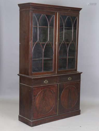 An early 20th century stained walnut bookcase cabinet