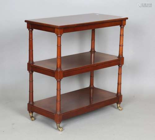 A 20th century reproduction mahogany three-tier étagère by A...