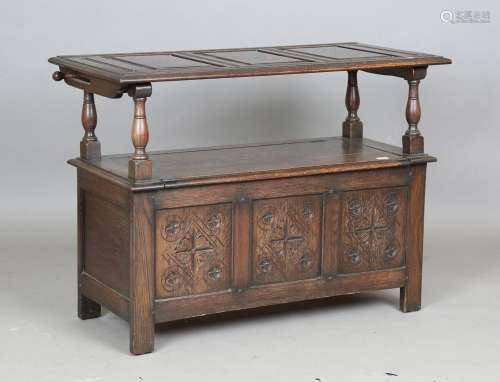 An early 20th century oak monk's bench with hinged top and b...