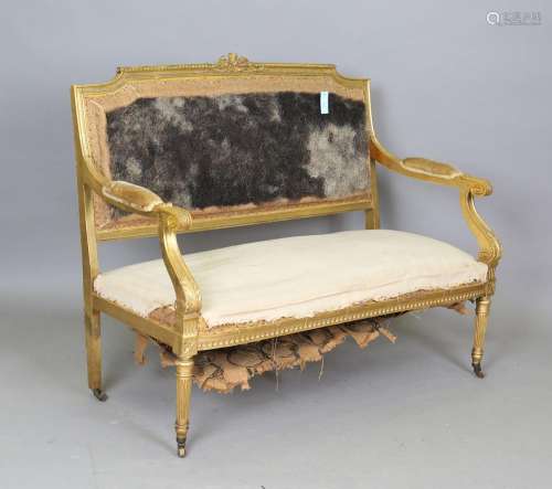 An early 20th century Louis XVI style giltwood settee with r...