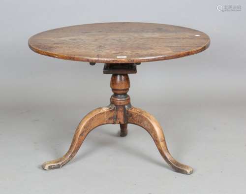 A George III provincial oak circular tip-top table with bird...