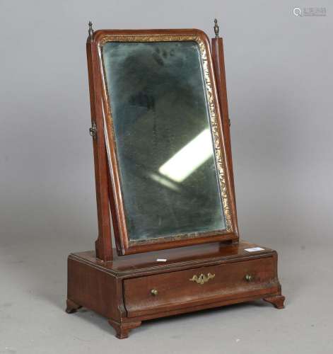 A George III mahogany swing frame mirror with a single friez...