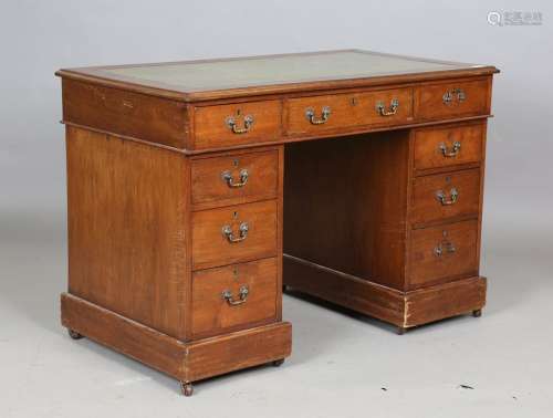A small late Victorian walnut twin pedestal desk