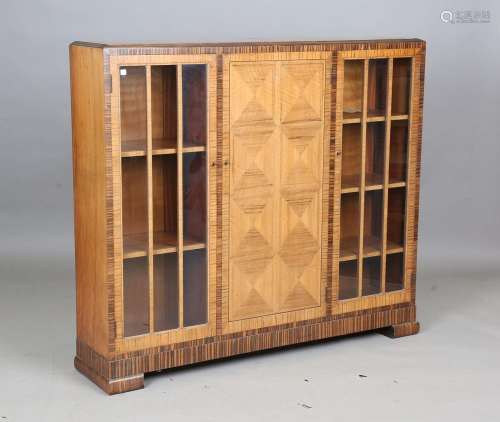 An Art Deco walnut and coromandel crossbanded bookcase by He...