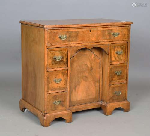 A George I style walnut kneehole writing desk