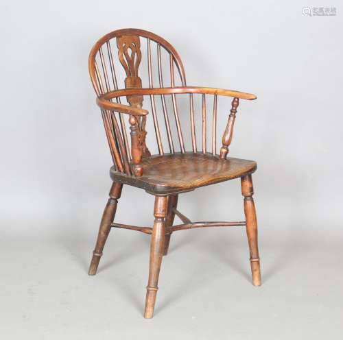 A 19th century yew and elm Windsor armchair with a pierced s...