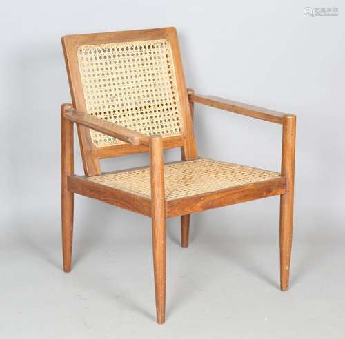 A mid-20th century teak framed armchair of retro design