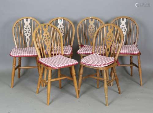 A set of six modern beech stick and wheel back kitchen chair...