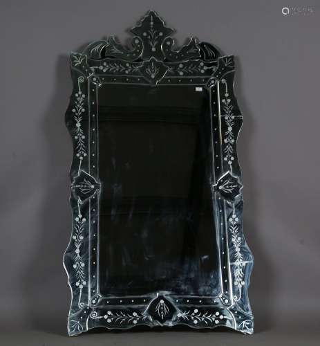 A large modern Venetian style wall mirror with etched sectio...