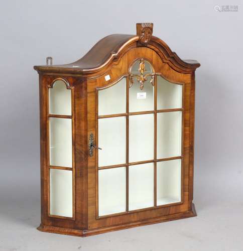 A 20th century Continental walnut wall cabinet of arched for...