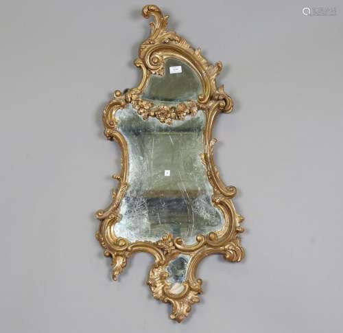 A Rococo giltwood wall mirror of asymmetrical scroll form wi...