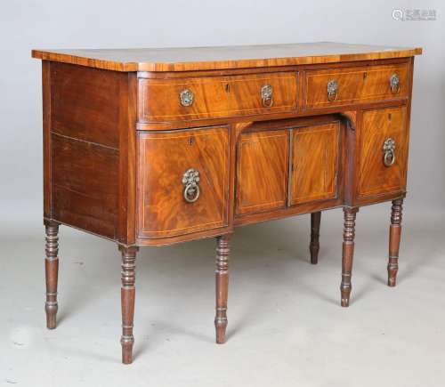 A George III mahogany break bowfront sideboard with a crossb...