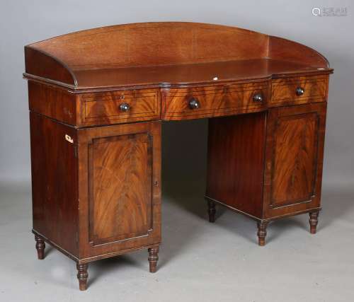 A Regency mahogany twin pedestal sideboard with ebony inlaid...