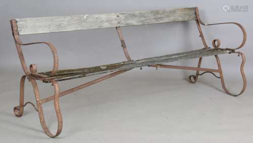 A 20th century wrought iron and slatted wooden garden bench