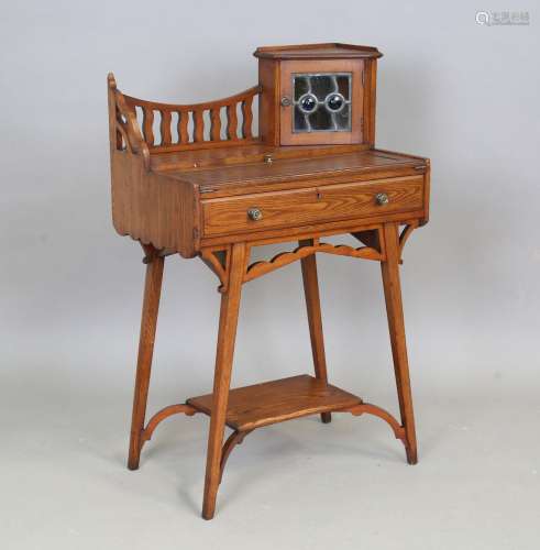 An early 20th century Arts and Crafts stained ash writing ta...
