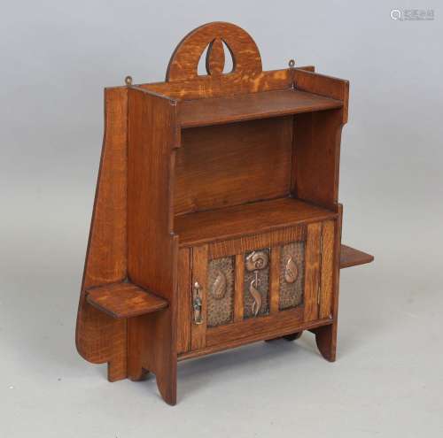 An Edwardian Arts and Crafts oak hanging wall cabinet by Sha...