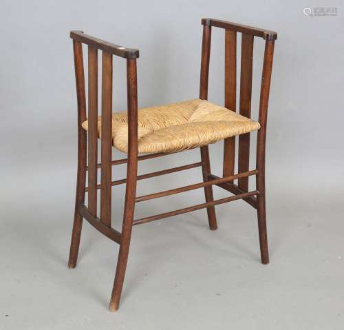 An Edwardian Arts and Crafts stained beech and mahogany wind...