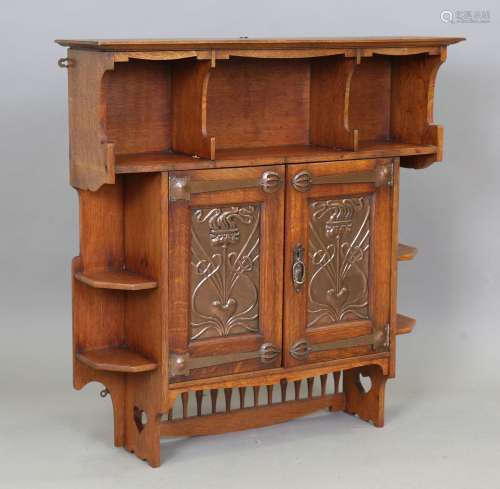 An Edwardian Arts and Crafts oak hanging wall cabinet by Sha...