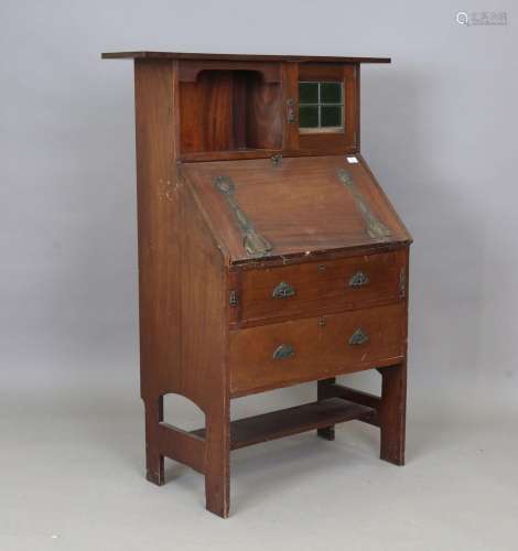 An Edwardian Arts and Crafts mahogany student's bureau, in t...