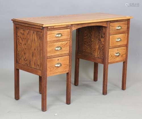 An early 20th century Arts and Crafts style oak desk, fitted...