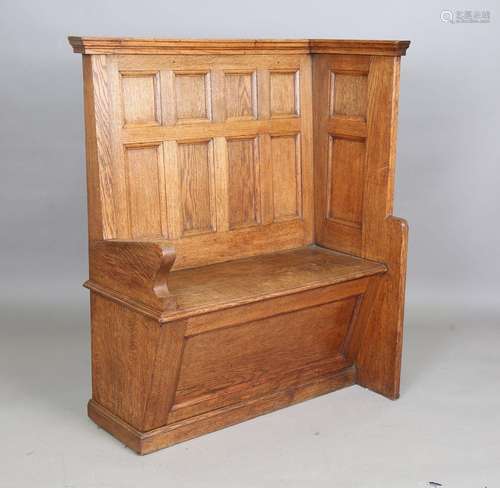 An early 20th century Arts and Crafts oak panelled hall benc...