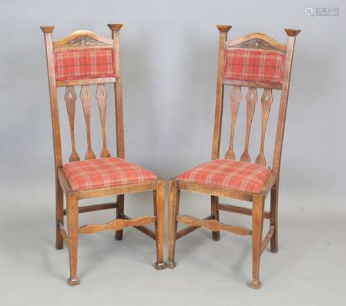 A pair of Edwardian Arts and Crafts oak framed side chairs, ...