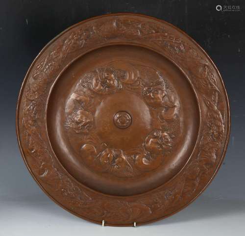 An Arts and Crafts copper charger by Morecambe HEC, the cent...