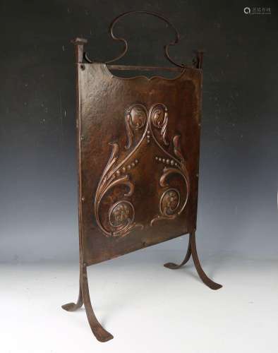 An Arts and Crafts copper and wrought iron framed firescreen...